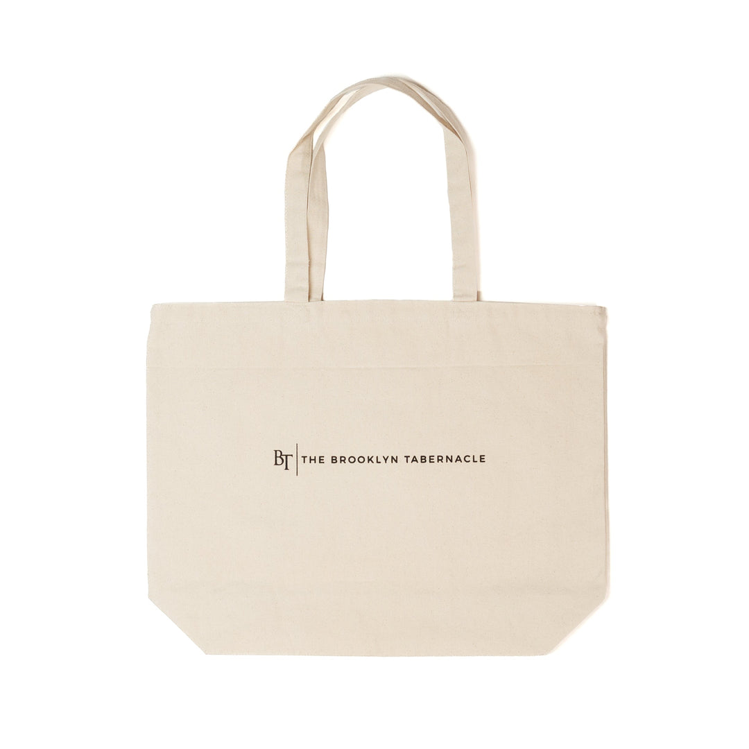 Beige tote bag with 'The Brooklyn Tabernacle' logo on a white background
